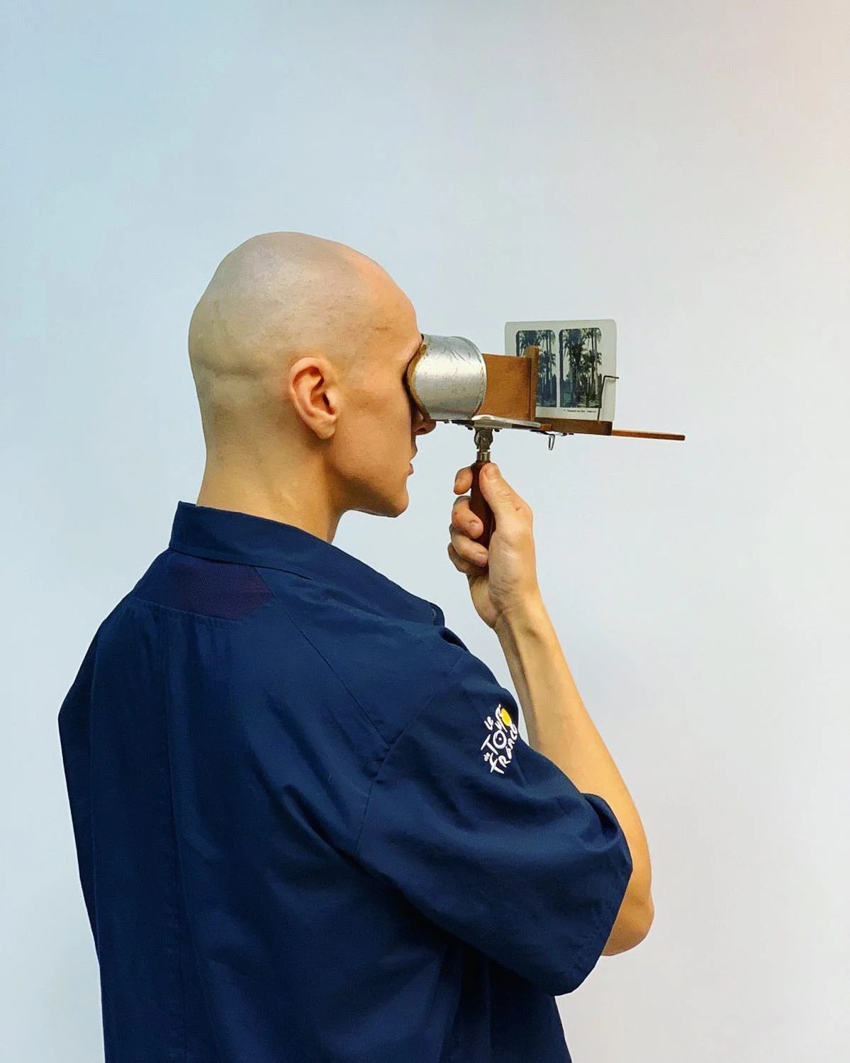 The artist looking through a stereoscope