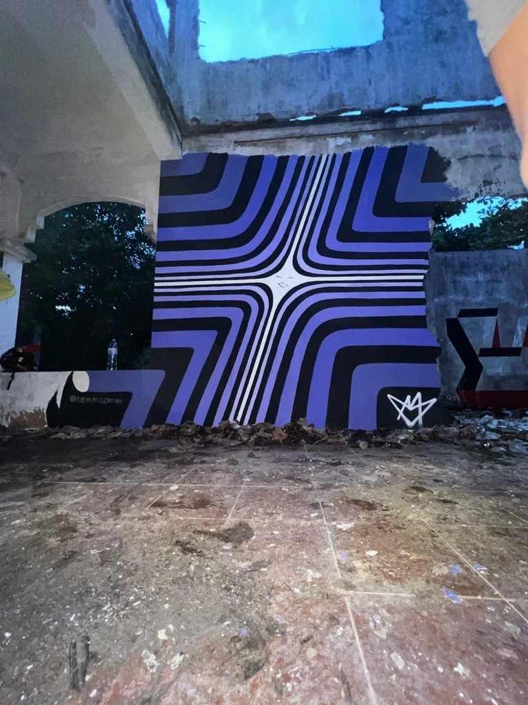 Birth of a Supernova: violet-and-black radiating optical mural in a ruined building